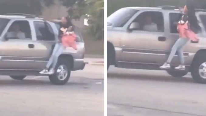 Woman Holds Onto Man's SUV While Caring A Baby In Her Arm