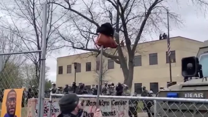 Minnesota Protester Taunts Cops With A Severed Pig's Head On A Pike