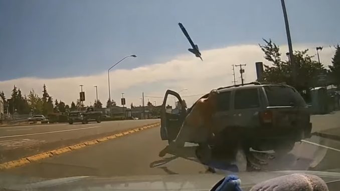 Enraged Driver Throws Pickaxe At Windshield During Road Rage Incident